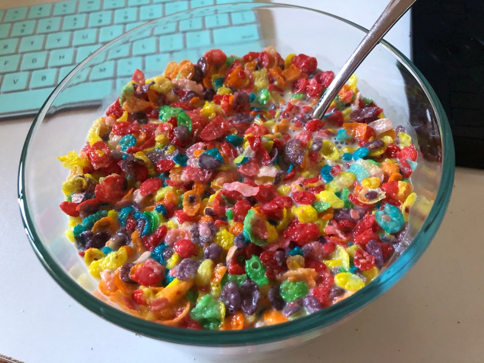 A picture of a bowl of Fruity Pebbles cereal.